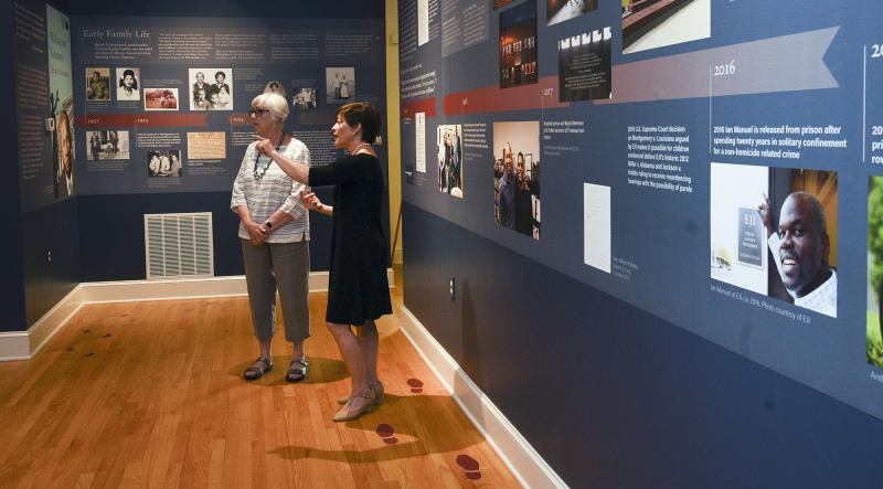 Heidi Evans explains the exhibit to Joy Kelly.